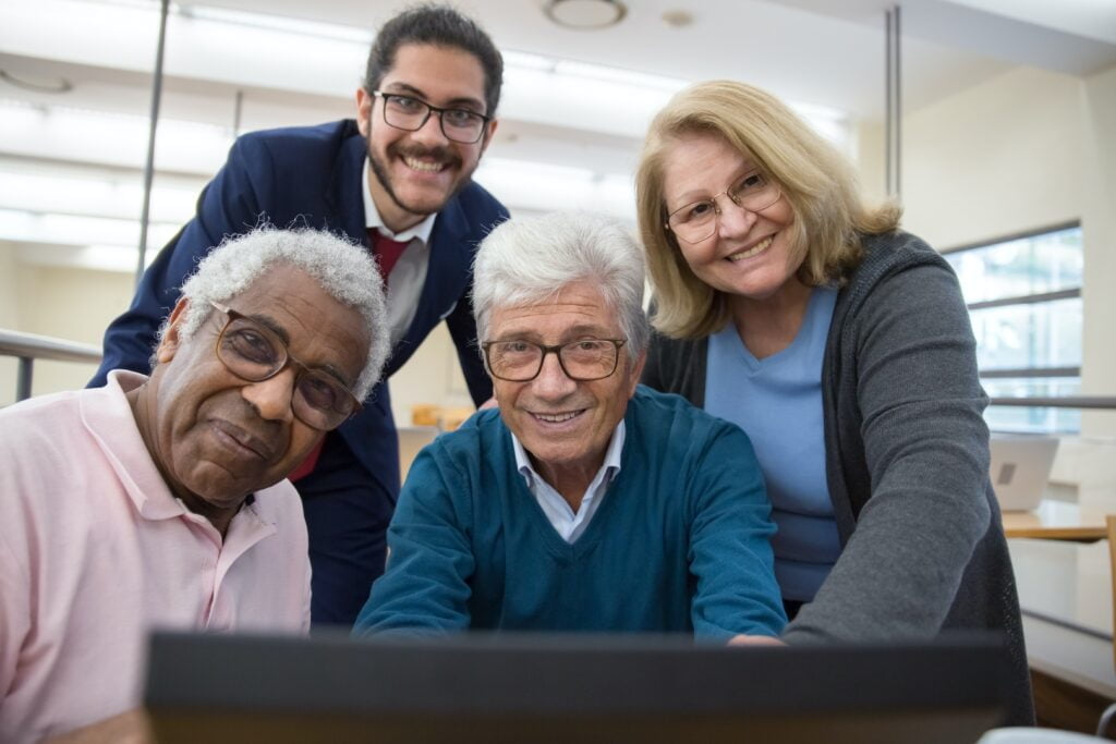 group of seniors around a computer